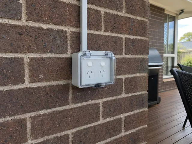 Outdoor double power point on a brick wall beside a covered patio in Wadalba